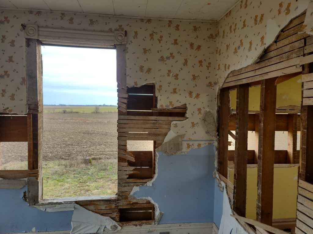 Window in a decaying, abandoned farmhouse.